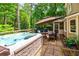 Backyard with a hot tub, lounge seating and mature landscaping, offering a private space at 4281 Chimney Lake Ne Dr, Roswell, GA 30075