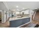 Modern kitchen with stainless steel appliances, white cabinetry, granite countertops, and backsplash at 4281 Chimney Lake Ne Dr, Roswell, GA 30075
