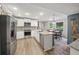 Modern kitchen with stainless steel appliances, white cabinetry, granite countertops, and backsplash at 4281 Chimney Lake Ne Dr, Roswell, GA 30075