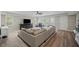 Spacious living room featuring a large sofa, neutral decor, and plenty of natural light at 4281 Chimney Lake Ne Dr, Roswell, GA 30075