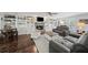 Cozy living room featuring a fireplace, built-in shelving, and hardwood floors at 4281 Chimney Lake Ne Dr, Roswell, GA 30075