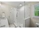 Modern bathroom showcases a frameless glass shower and stylish white tile work at 4281 Chimney Lake Ne Dr, Roswell, GA 30075