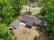 Aerial view of a home and large backyard, with a screened in porch and mature trees at 4356 Executive Dr, Stone Mountain, GA 30083
