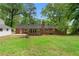 A nice backyard featuring a lush lawn, a storage building and a screened in porch for entertaining at 4356 Executive Dr, Stone Mountain, GA 30083