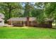 A lovely screened in porch highlights the well maintained brick home and large, grassy backyard at 4356 Executive Dr, Stone Mountain, GA 30083