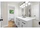 Bathroom with a modern double vanity, a large mirror, and a bright light fixture at 4356 Executive Dr, Stone Mountain, GA 30083