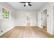Bedroom with light hardwood floors and an open door to a connected bathroom at 4356 Executive Dr, Stone Mountain, GA 30083