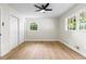 A bedroom featuring hardwood floors, ceiling fan, and double windows at 4356 Executive Dr, Stone Mountain, GA 30083