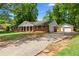 Spacious ranch home with detached garages and a long driveway at 4356 Executive Dr, Stone Mountain, GA 30083