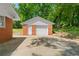 Detached garage with white doors, and a red brick accent at 4356 Executive Dr, Stone Mountain, GA 30083