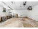 Spacious garage interior featuring a concrete floor, white walls, and a window at 4356 Executive Dr, Stone Mountain, GA 30083