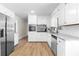 Bright kitchen featuring white cabinets, stainless steel appliances, and a large window at 4356 Executive Dr, Stone Mountain, GA 30083