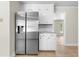 Kitchen with stainless steel refrigerator and white cabinets for ample storage at 4356 Executive Dr, Stone Mountain, GA 30083