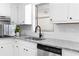 Bright kitchen featuring white cabinetry, granite countertops, and stainless steel appliances at 4356 Executive Dr, Stone Mountain, GA 30083