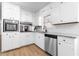 Charming kitchen featuring white cabinets, stainless steel appliances, and granite countertops at 4356 Executive Dr, Stone Mountain, GA 30083