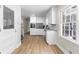 Stylish kitchen with white cabinets, stainless steel appliances, and hardwood floors at 4356 Executive Dr, Stone Mountain, GA 30083