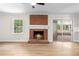 Cozy living room with a brick fireplace, mantle, and a large window for natural light at 4356 Executive Dr, Stone Mountain, GA 30083