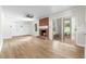 Bright living room featuring a brick fireplace, built-in shelving, and sliding glass doors at 4356 Executive Dr, Stone Mountain, GA 30083