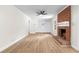 Spacious living room with a brick fireplace, built-in shelving, and hardwood floors at 4356 Executive Dr, Stone Mountain, GA 30083