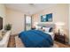 Nicely staged bedroom with blue comforter, hardwood floors, and natural lighting at 5485 Sierra Trl, Atlanta, GA 30349