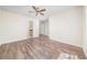Spacious bedroom with wood-look flooring, a ceiling fan, and plenty of room to create the perfect space at 5485 Sierra Trl, Atlanta, GA 30349