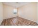 Empty bedroom featuring wood flooring, a window, and neutral paint at 5485 Sierra Trl, Atlanta, GA 30349