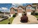 Desirable townhome complex featuring well-maintained lawns and attractive brick and siding exteriors on a sunny day at 5485 Sierra Trl, Atlanta, GA 30349