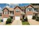 Attractive townhome featuring a brick front, attached garage, and well-maintained landscaping enhancing its curb appeal at 5485 Sierra Trl, Atlanta, GA 30349