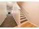 Hallway with stairs to the second floor, wood and carpet flooring at 5485 Sierra Trl, Atlanta, GA 30349