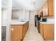 View of kitchen with black appliances and adjacent view of living area at 5485 Sierra Trl, Atlanta, GA 30349