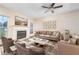 Cozy living room featuring a fireplace, plush seating, ceiling fan, and neutral decor perfect for relaxation at 5485 Sierra Trl, Atlanta, GA 30349