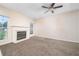 Inviting living room showcasing a fireplace, large window, neutral carpet and plenty of natural light at 5485 Sierra Trl, Atlanta, GA 30349