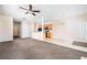 Open-concept living room and kitchen with ceiling fan and neutral color palette at 5485 Sierra Trl, Atlanta, GA 30349