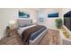 Well-lit main bedroom with hardwood flooring, neutral decor and artwork at 5485 Sierra Trl, Atlanta, GA 30349