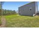 Spacious backyard with lawn, trees, and patio is great for outdoor entertaining and relaxation at 8491 Limerick Ln, Winston, GA 30187