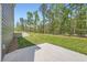 A concrete patio and lush lawn offer outdoor enjoyment in this verdant backyard at 8491 Limerick Ln, Winston, GA 30187