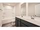 This bathroom features a double sink vanity, framed mirrors, and a shower-tub combination at 8491 Limerick Ln, Winston, GA 30187