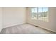Bright, carpeted bedroom showcasing ample natural light through a large window at 8491 Limerick Ln, Winston, GA 30187