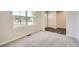 Sunlit room view showcasing new carpeting, large windows and modern design at 8491 Limerick Ln, Winston, GA 30187