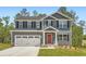 Charming two-story home with gray siding, black shutters, and a two-car garage at 8491 Limerick Ln, Winston, GA 30187
