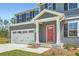 Inviting front porch with a vibrant red door, leading to a well-maintained two-story home at 8491 Limerick Ln, Winston, GA 30187
