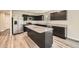 Modern kitchen featuring dark cabinets, granite countertops, stainless steel appliances, and island at 8491 Limerick Ln, Winston, GA 30187