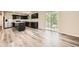 Modern kitchen with stainless steel appliances, dark cabinetry, and island, open to dining area at 8491 Limerick Ln, Winston, GA 30187