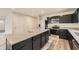 Beautiful kitchen with stainless appliances, dark cabinetry, granite island, and hardwood floors at 8491 Limerick Ln, Winston, GA 30187