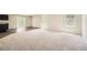 Spacious living room with plush carpeting and bright natural light from sliding doors at 8491 Limerick Ln, Winston, GA 30187
