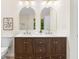 Bathroom with double sinks, wood cabinets, framed mirrors, and modern lighting at 223 Old Alabama Se Rd, Emerson, GA 30137