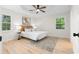 Light-filled bedroom with ceiling fan, wood floors, neutral paint, and a decorative rug at 223 Old Alabama Se Rd, Emerson, GA 30137