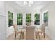 Sunlit dining area boasts large windows, tray ceiling, modern lighting, and wood floors at 223 Old Alabama Se Rd, Emerson, GA 30137