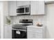 Bright kitchen features stainless steel appliances, white cabinets, and tile backsplash at 223 Old Alabama Se Rd, Emerson, GA 30137