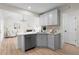 Modern kitchen with gray cabinets, breakfast bar, and open access to living area at 223 Old Alabama Se Rd, Emerson, GA 30137